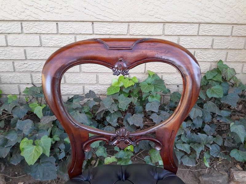 A 20th Century Set Of Twelve Teak Wood Bustle Back Chairs Comprising A Pair Of Carvers / Armchair...