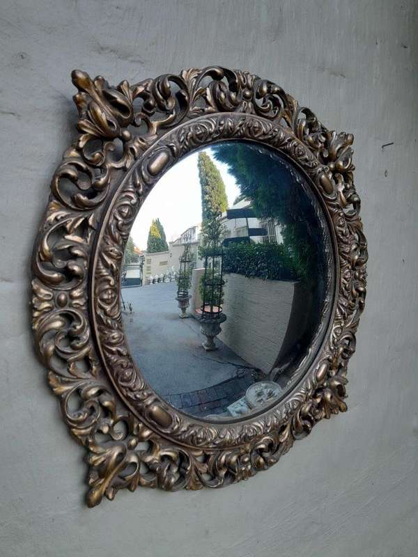 A 20th Century Ornately Carved Convex Mirror