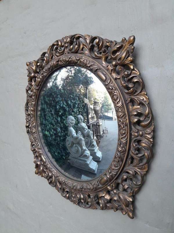 A 20th Century Ornately Carved Convex Mirror