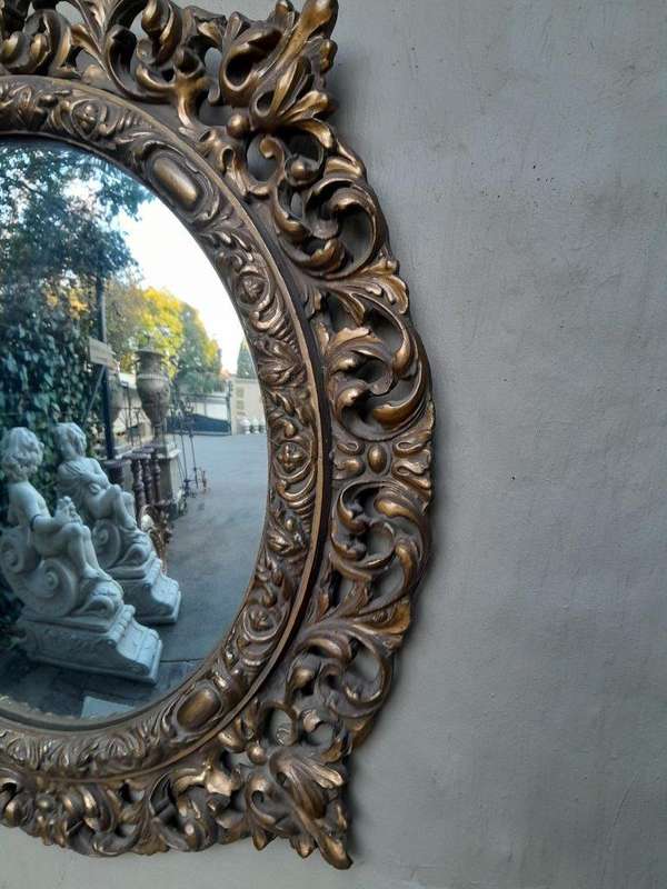 A 20th Century Ornately Carved Convex Mirror