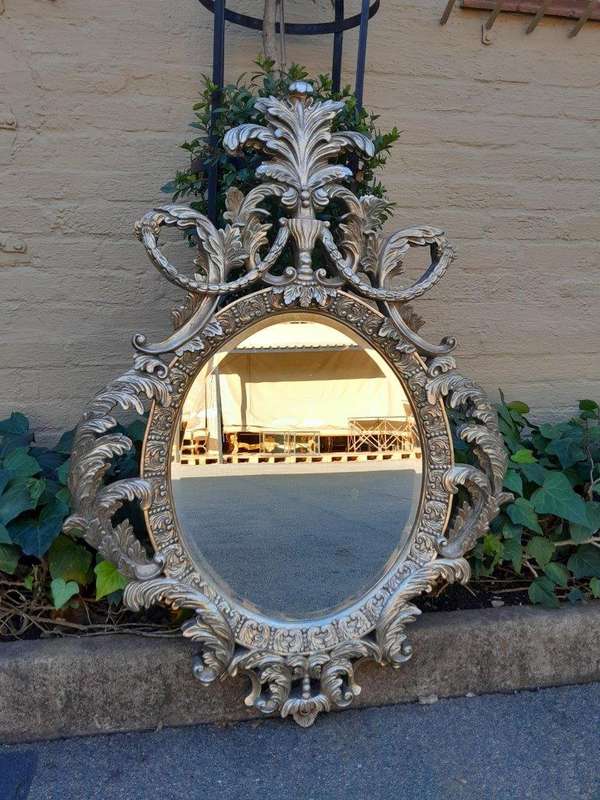 A French Style Ornately Carved And Bevelled Mirror In A Contemporary Silver Hand-Gilded Finish