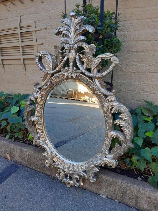 A French Style Ornately Carved And Bevelled Mirror In A Contemporary Silver Hand-Gilded Finish