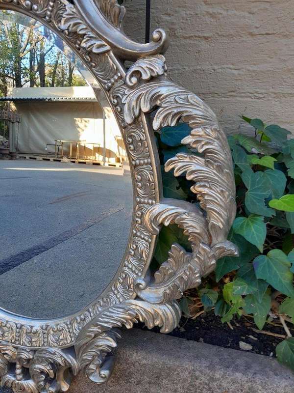 A French Style Ornately Carved And Bevelled Mirror In A Contemporary Silver Hand-Gilded Finish
