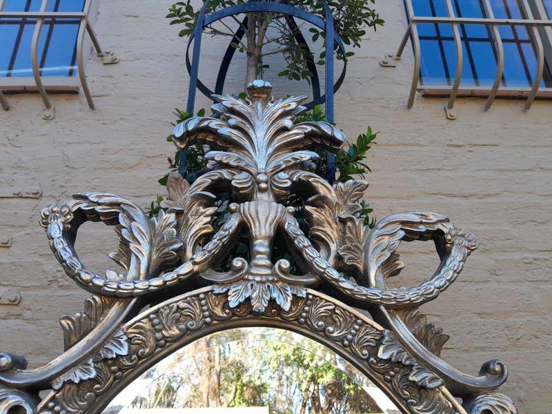 A French Style Ornately Carved And Bevelled Mirror In A Contemporary Silver Hand-Gilded Finish