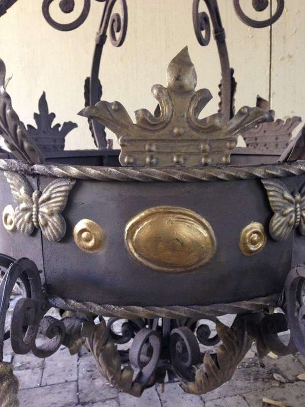 A Large Wrought Iron and Hand-Painted Imported Chandelier with Crown Detail