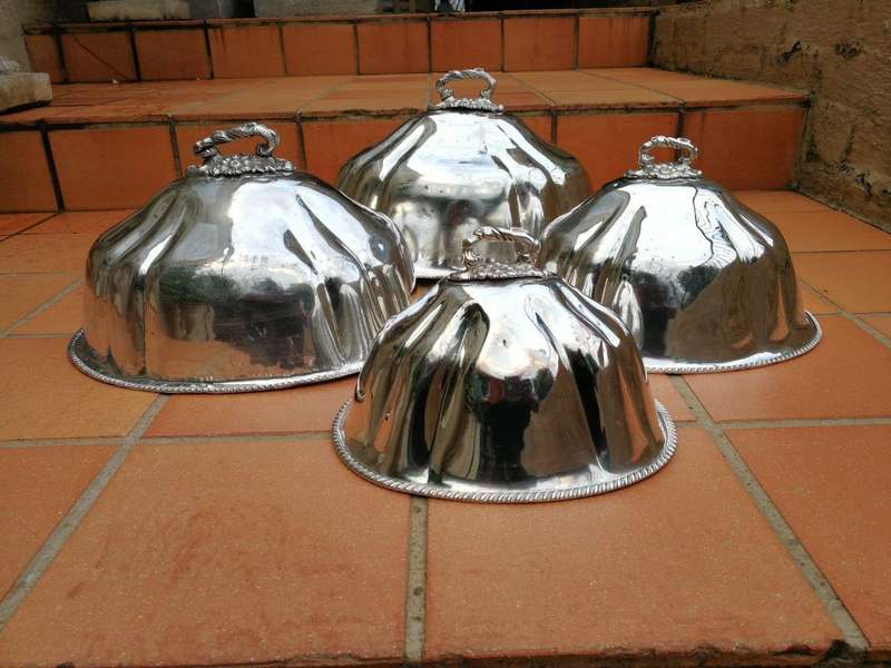 A late 19th century set of four graduated silver-plate food domes ND