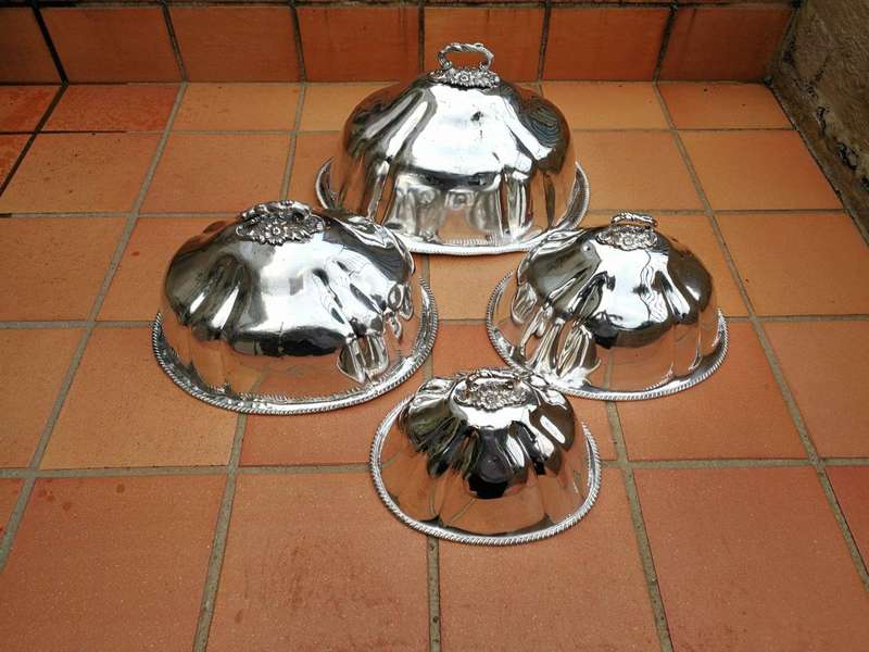 A late 19th century set of four graduated silver-plate food domes ND
