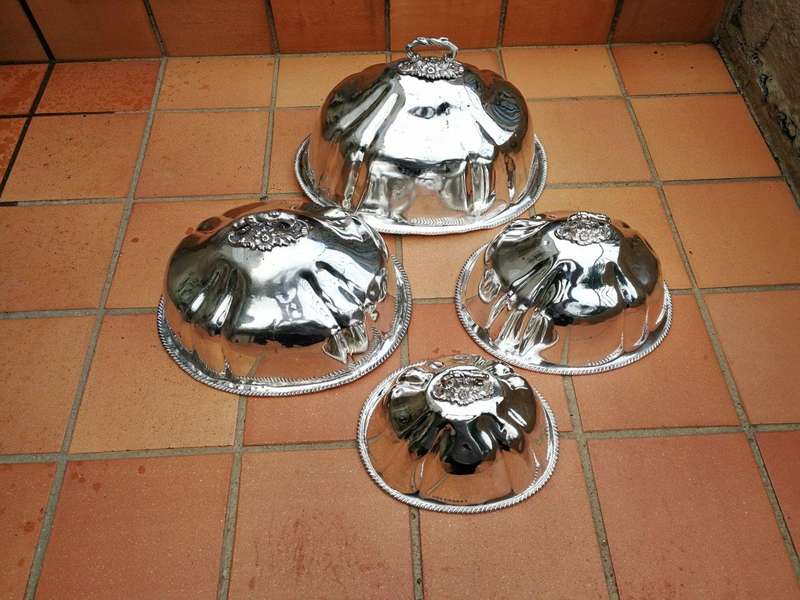 A late 19th century set of four graduated silver-plate food domes ND