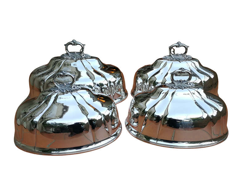 A Set Of Four Silver-Plate Food Domes