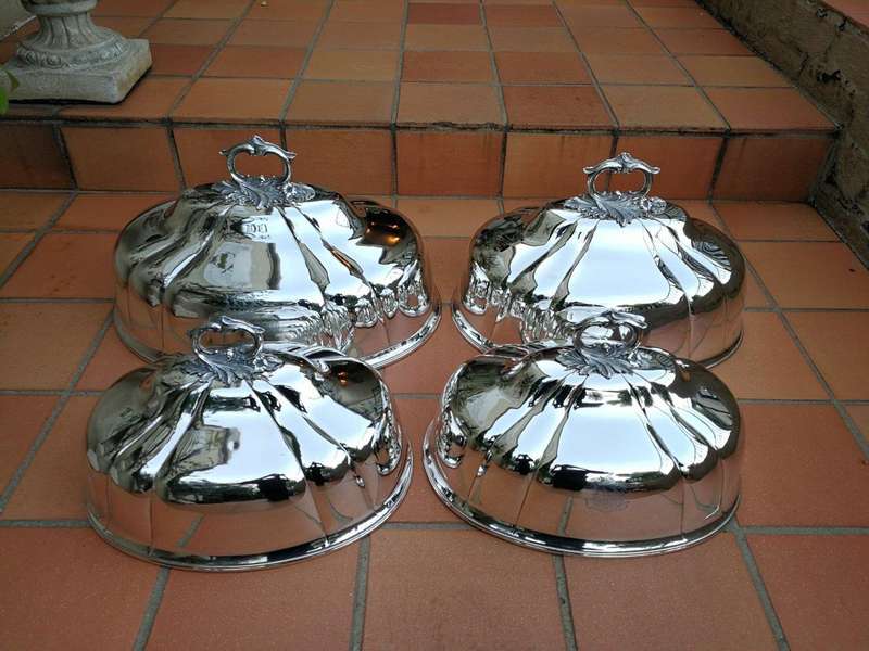A Set Of Four Silver-Plate Food Domes