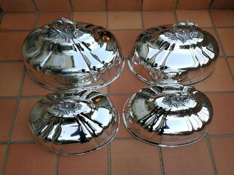 A Set Of Four Silver-Plate Food Domes