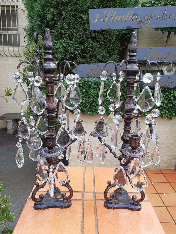 A pair of cast-iron and crystal candelabras