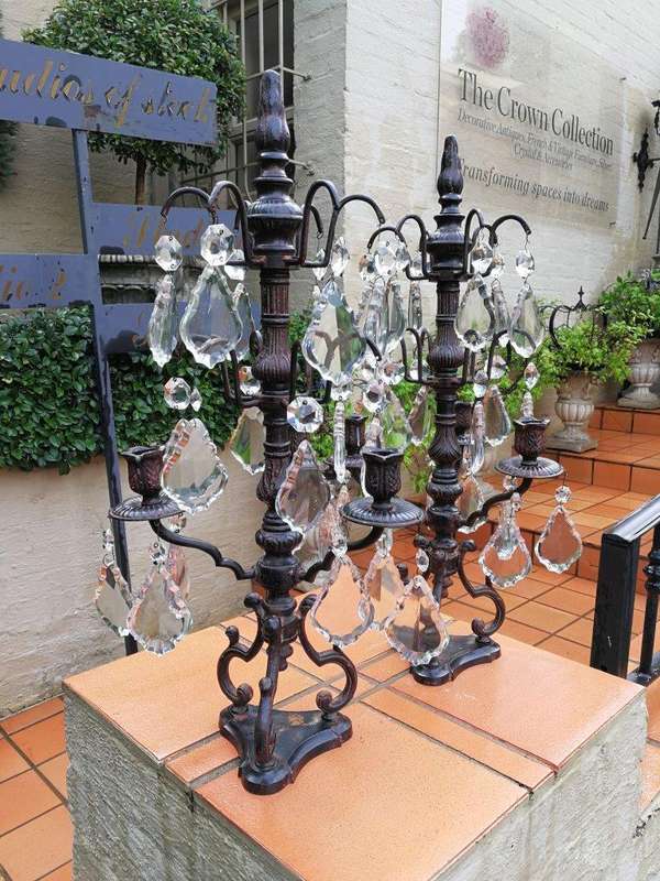 A pair of cast-iron and crystal candelabras