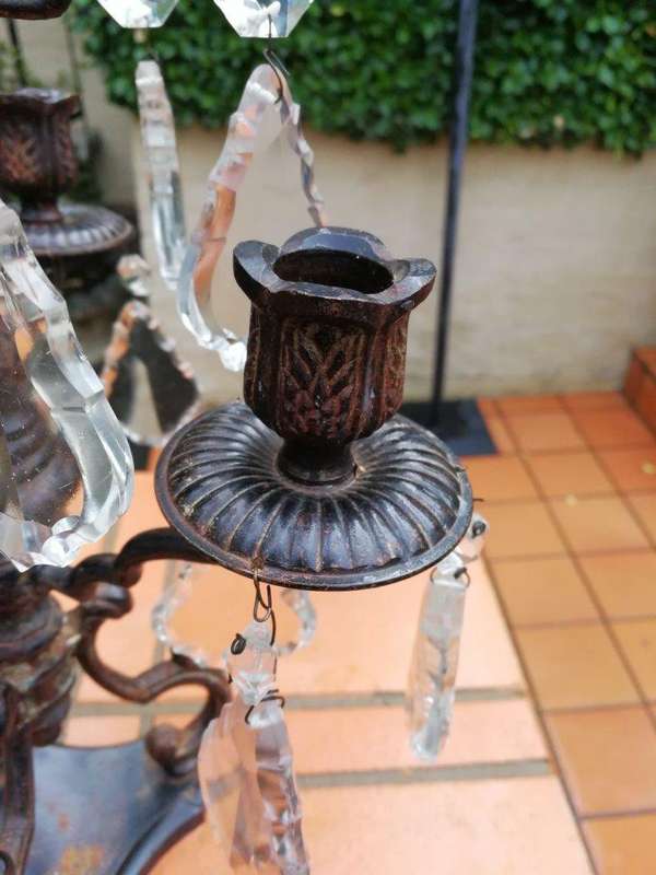 A pair of cast-iron and crystal candelabras