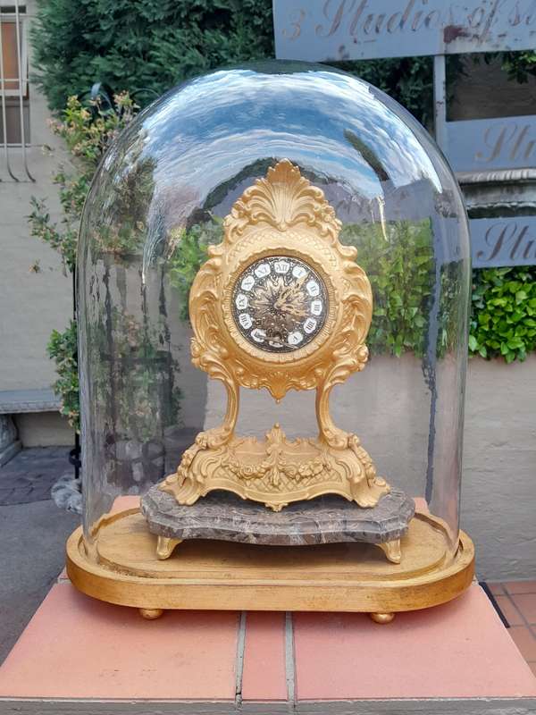 A 19th Century French Gilt Metal Clock in Glass Cloche with Hand Gilded Wooden Base