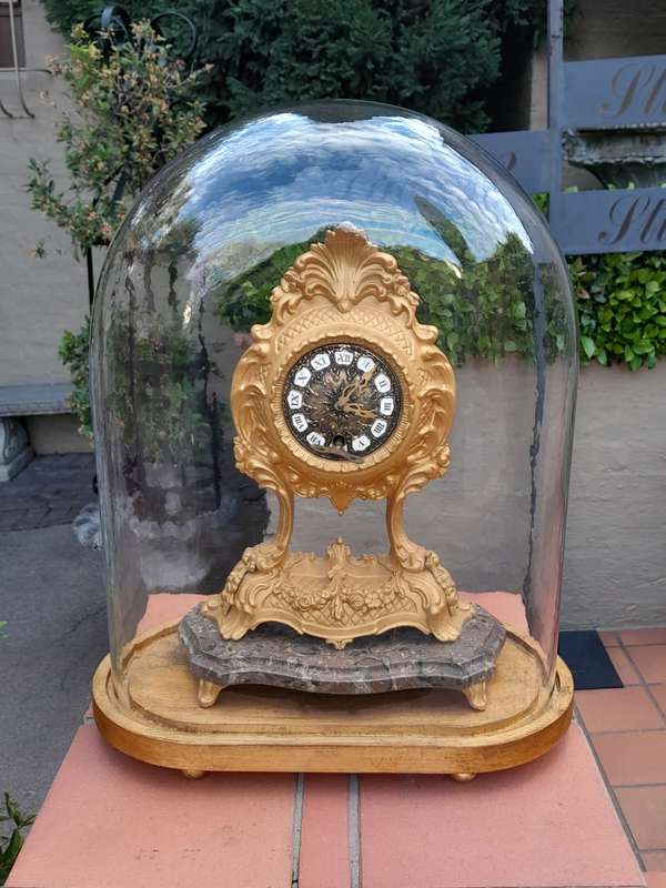 A 19th Century French Gilt Metal Clock in Glass Cloche with Hand Gilded Wooden Base
