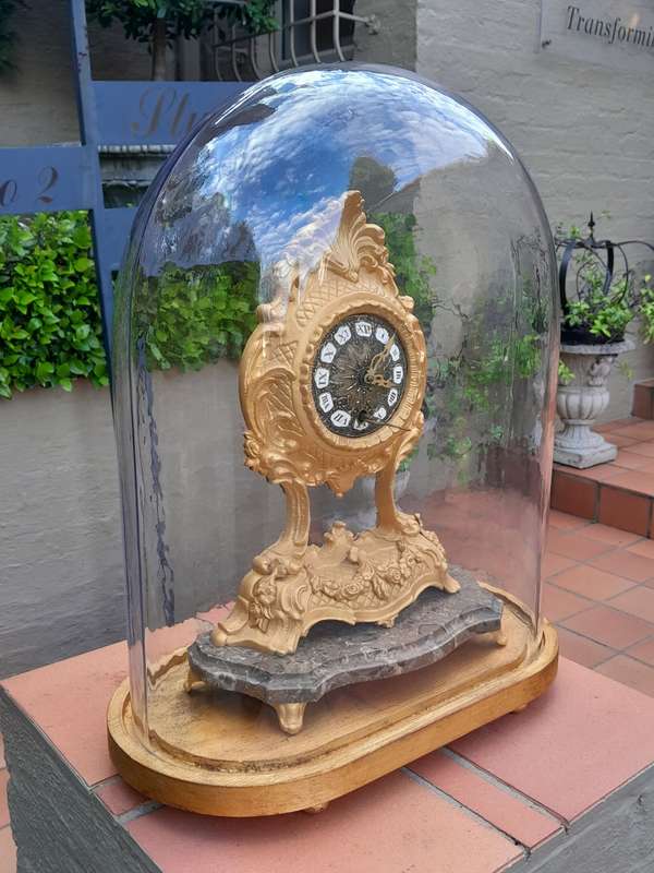 A 19th Century French Gilt Metal Clock in Glass Cloche with Hand Gilded Wooden Base