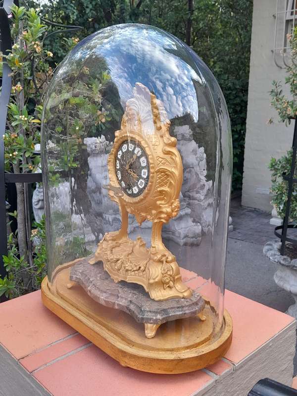 A 19th Century French Gilt Metal Clock in Glass Cloche with Hand Gilded Wooden Base