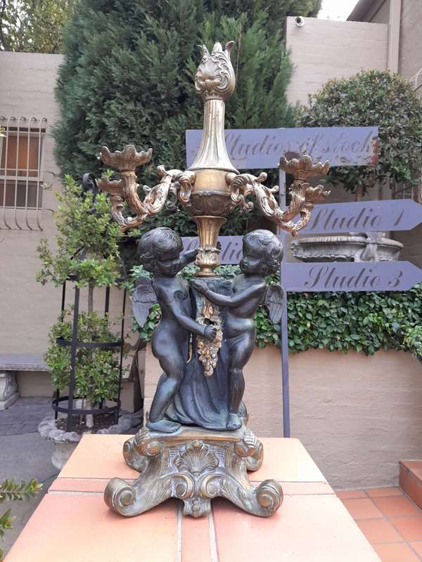 An Antique Brass And Bronze Five Arm Cherub Candelabra