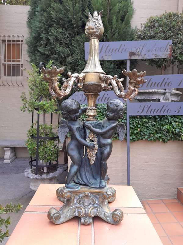 An Antique Brass And Bronze Five Arm Cherub Candelabra