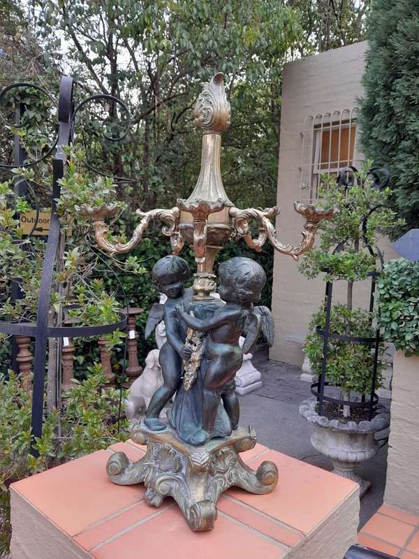 An Antique Brass And Bronze Five Arm Cherub Candelabra