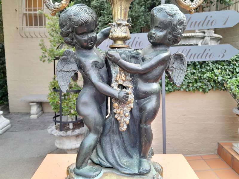 An Antique Brass And Bronze Five Arm Cherub Candelabra