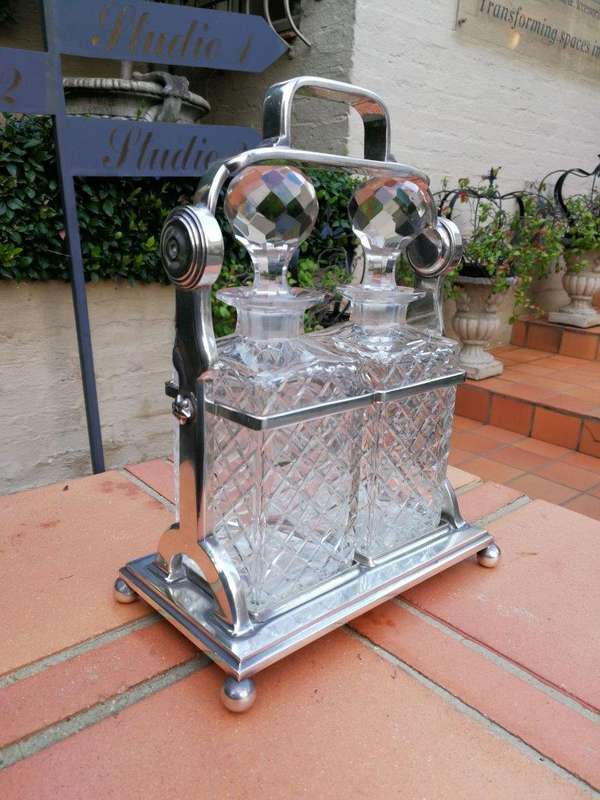 A Silver- Plate Tantalus With Two Cut-Glass Decanters