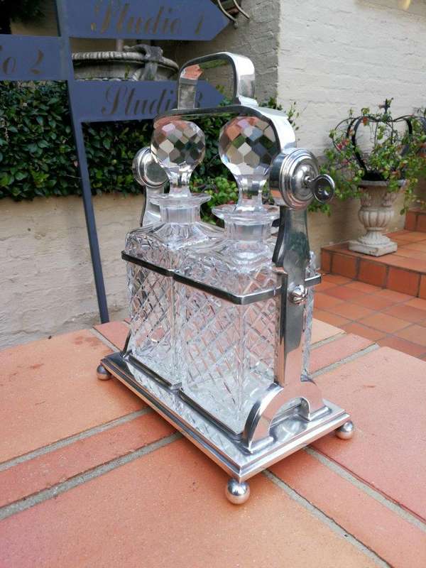 A Silver- Plate Tantalus With Two Cut-Glass Decanters