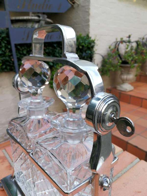 A Silver- Plate Tantalus With Two Cut-Glass Decanters