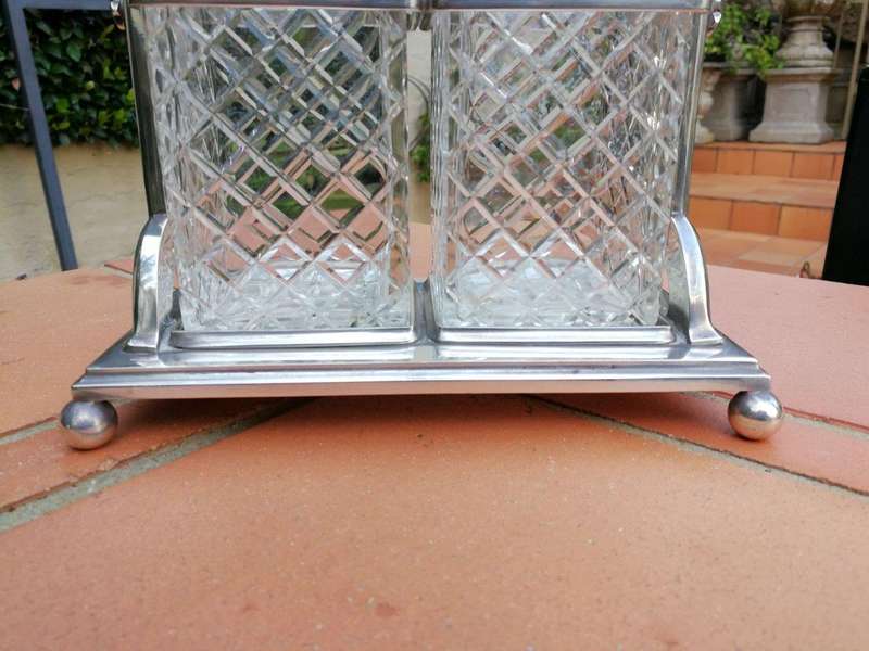 A Silver- Plate Tantalus With Two Cut-Glass Decanters