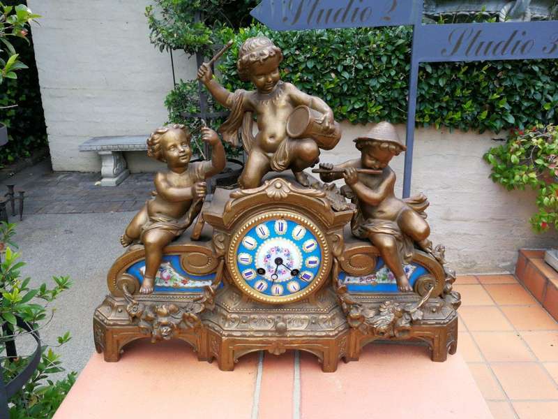 A 20th Century French Spelter And Gilt And Spelter Clock With Porcelain Plaques.  Has Key And Pe...