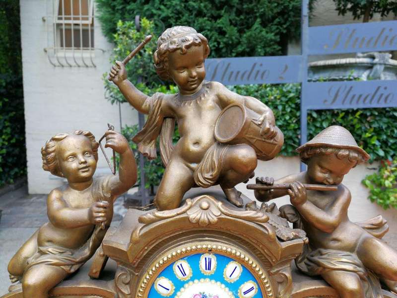 A 20th Century French Spelter And Gilt And Spelter Clock With Porcelain Plaques.  Has Key And Pe...