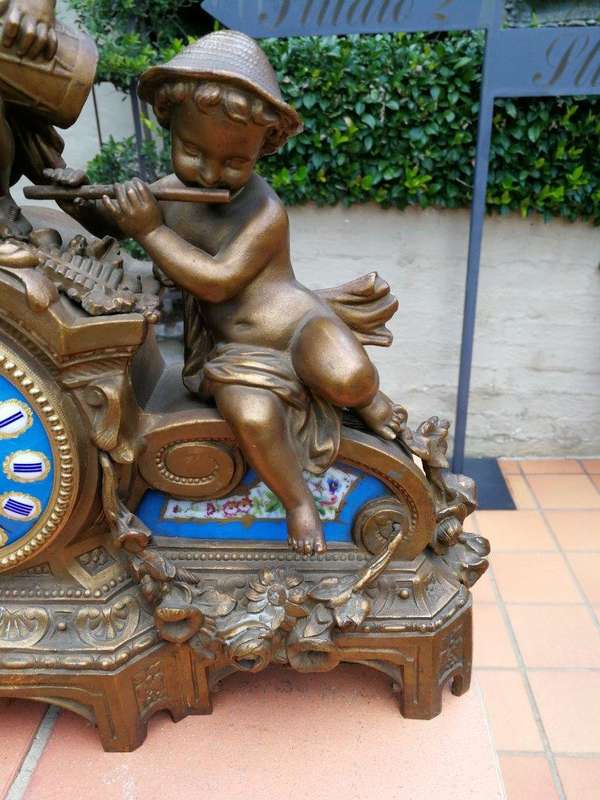 A 20th Century French Spelter And Gilt And Spelter Clock With Porcelain Plaques.  Has Key And Pe...
