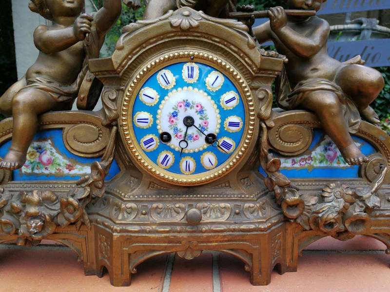 A 20th Century French Spelter And Gilt And Spelter Clock With Porcelain Plaques.  Has Key And Pe...