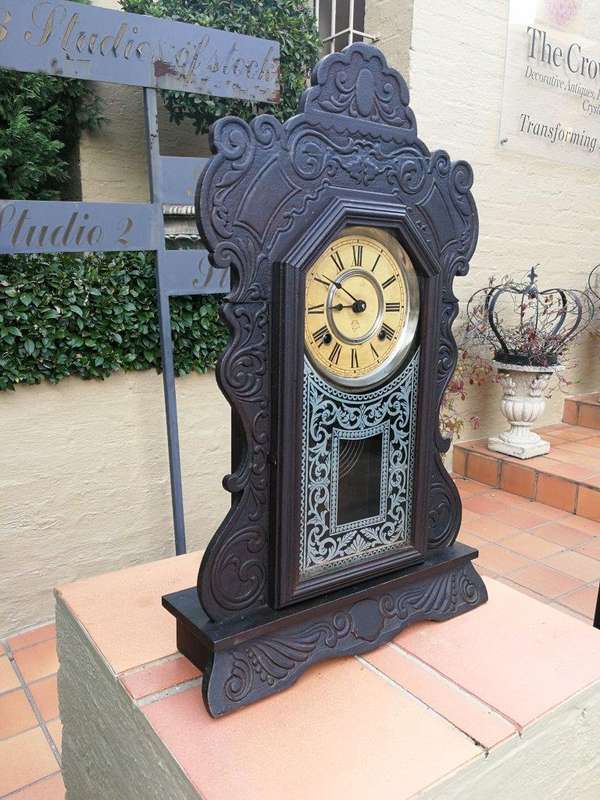 An Early 20th Century American Ebonised & Ornate Carved Oak Mantel Clock