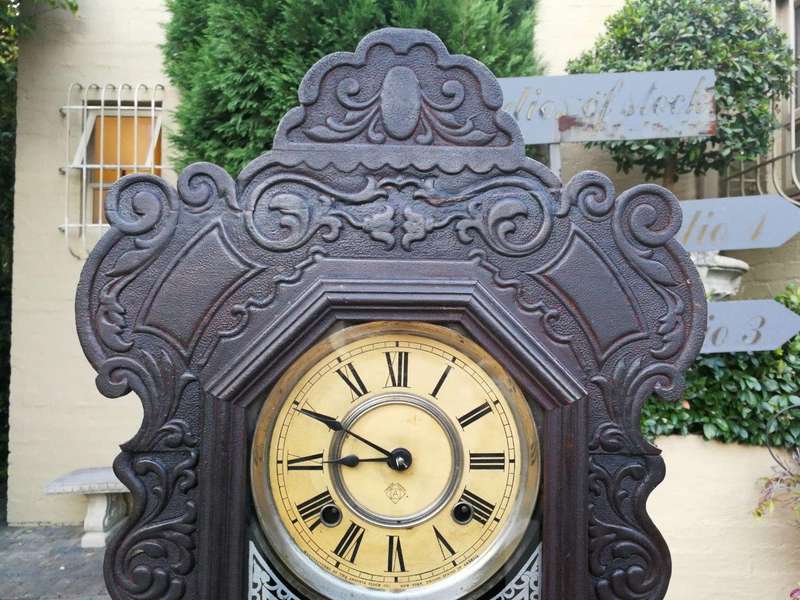An Early 20th Century American Ebonised & Ornate Carved Oak Mantel Clock