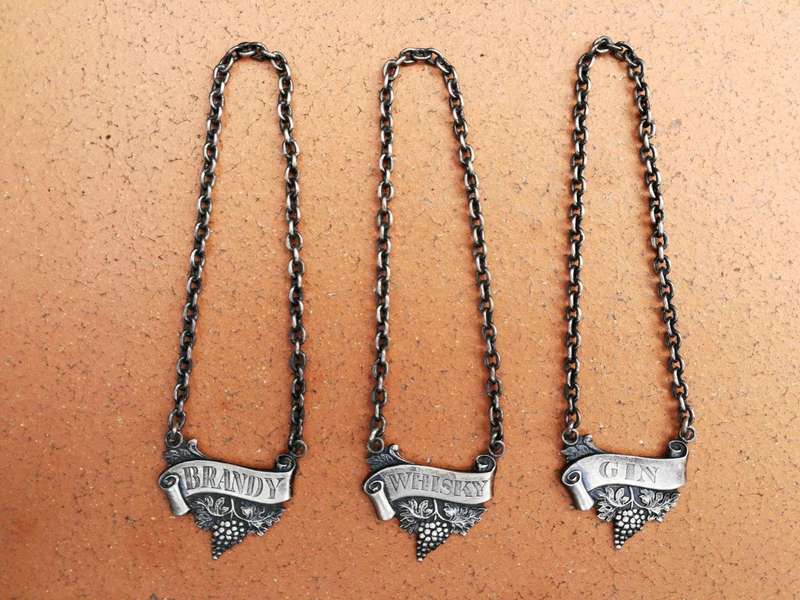 A Set of Three Birmingham Silver Decanter Labels Silver weight: 34 grams