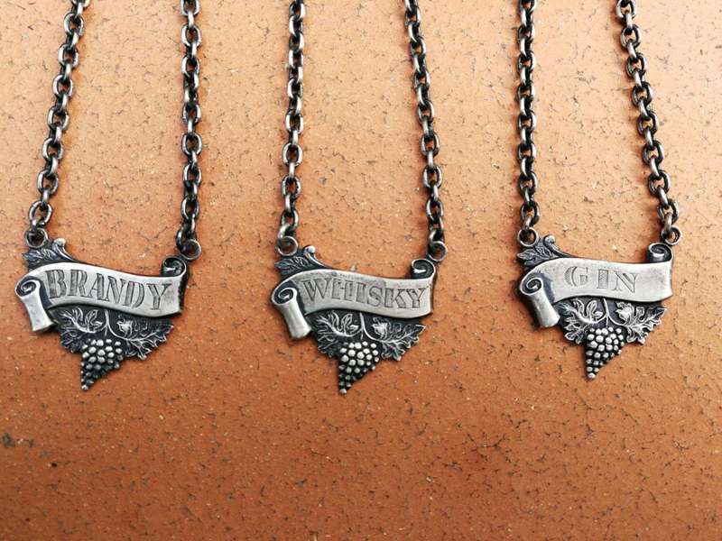 A Set of Three Birmingham Silver Decanter Labels Silver weight: 34 grams