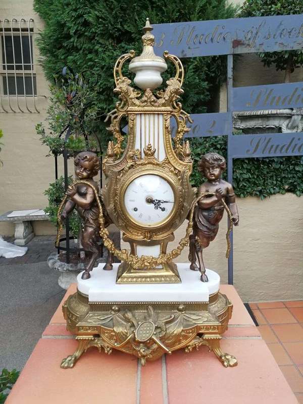 An Antique Circa Early 1900 Brass Garniture Clock Set with Key. Comprising a Clock and Pair of Ca...