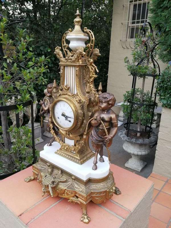 An Antique Circa Early 1900 Brass Garniture Clock Set with Key. Comprising a Clock and Pair of Ca...