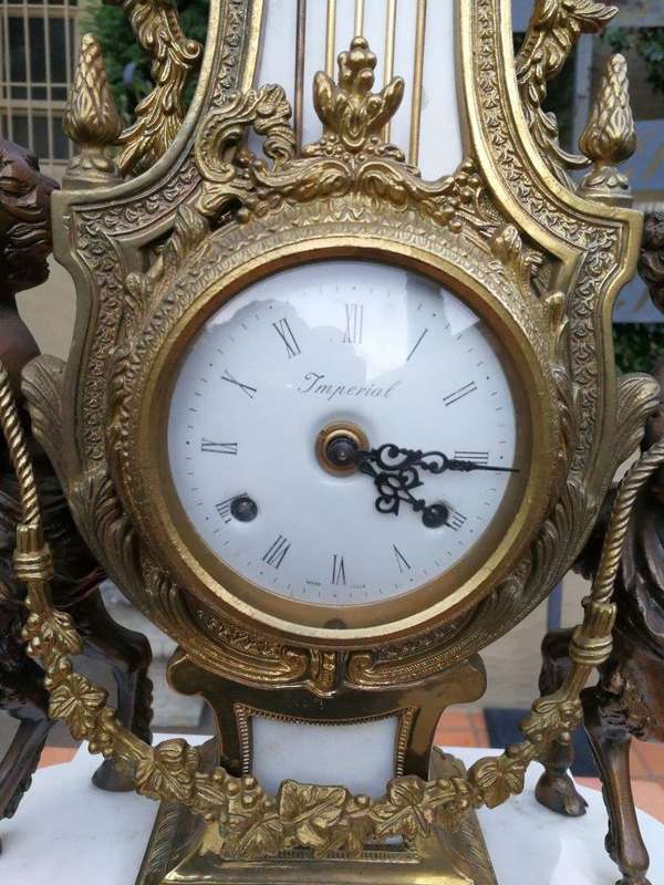 An Antique Circa Early 1900 Brass Garniture Clock Set with Key. Comprising a Clock and Pair of Ca...