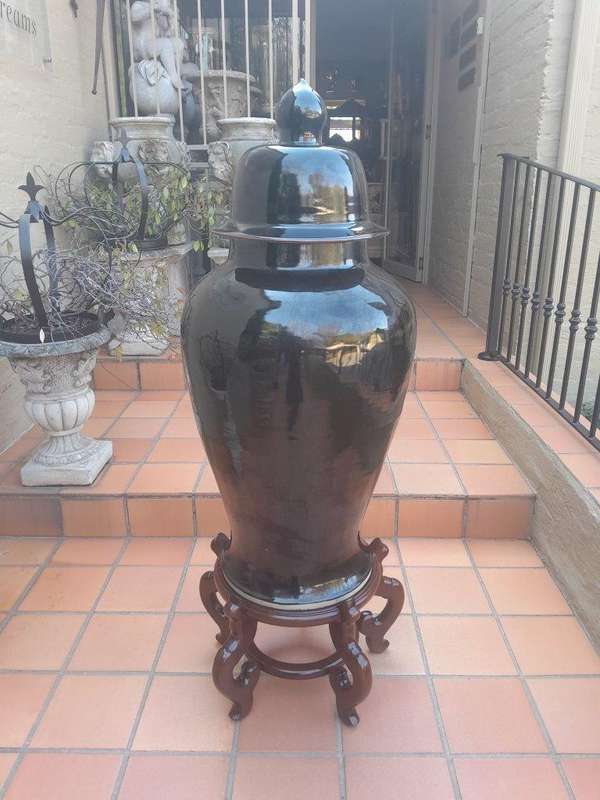 A Large Size Black Ceramic Ginger Car With Cover On A Chinese Wooden Stand