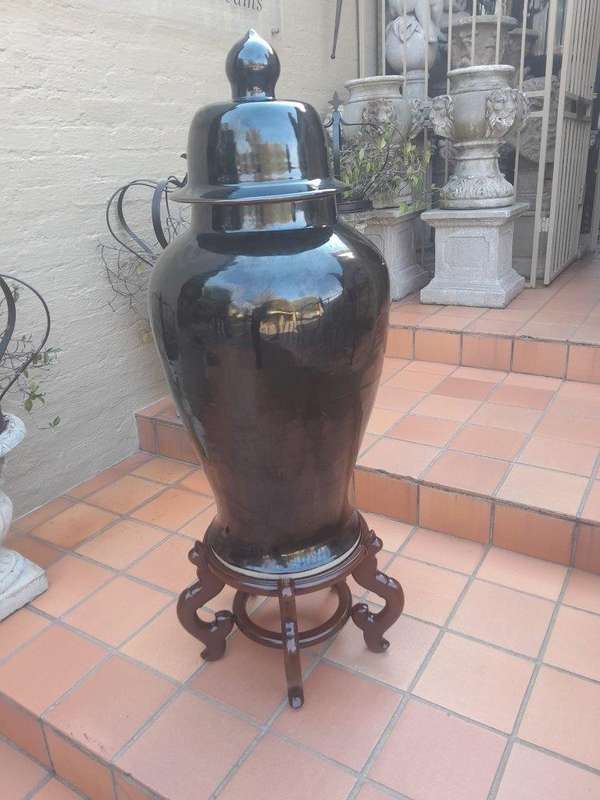A Large Size Black Ceramic Ginger Car With Cover On A Chinese Wooden Stand