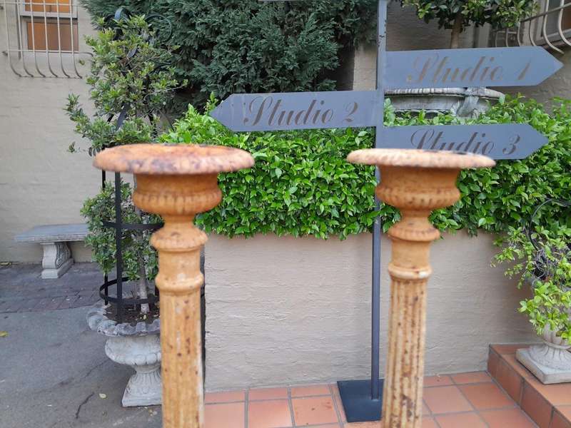 A 20th Century French Pair Of Cast Iron Candle Sticks