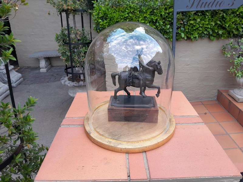A Bronze Male Figurine On Horseback On Wooden Base In A Glass Cloche