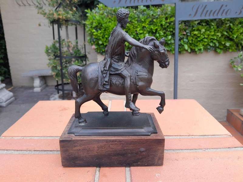 A Bronze Male Figurine On Horseback On Wooden Base In A Glass Cloche