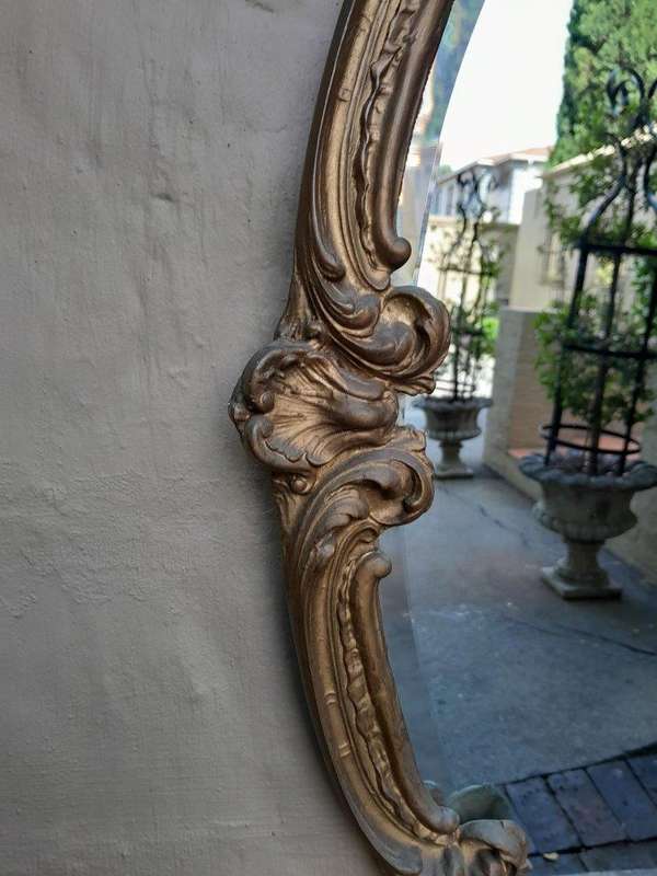 A French Style Ornately Carved Gilt Wood Bevelled Mirror