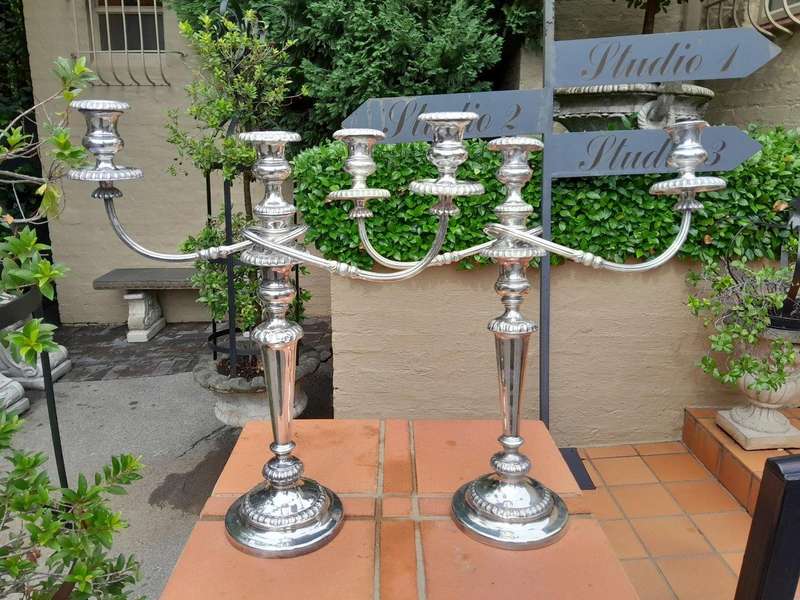 A 20TH Century Pair of Silver Plated Embossed Candelabra