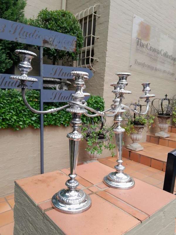 A 20TH Century Pair of Silver Plated Embossed Candelabra