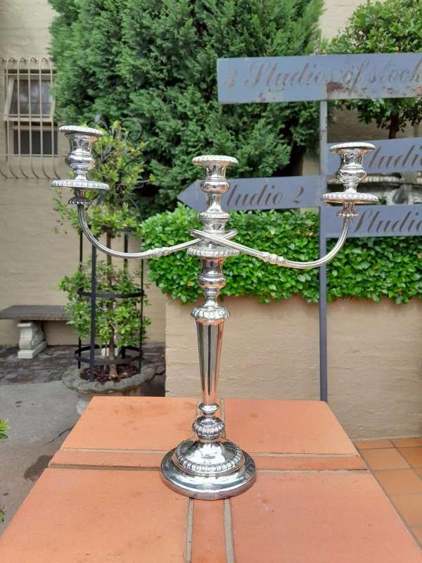 A 20TH Century Pair of Silver Plated Embossed Candelabra